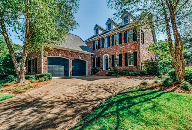 Traditional brick home representing buying and selling a home with intention